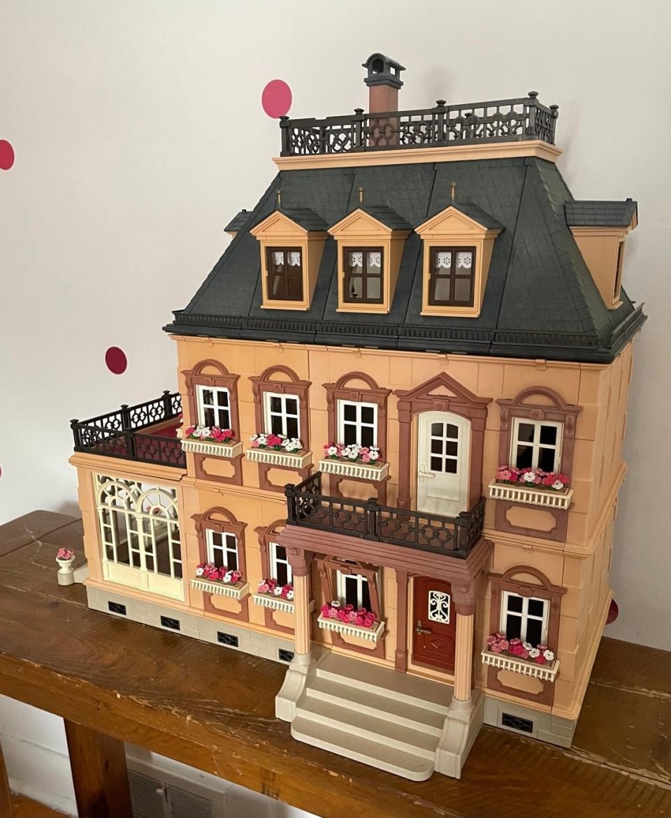 three story mansion replica on a table