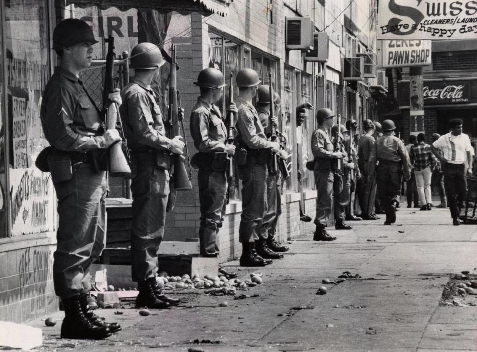 National Guardsmen stood with rifles ready in front of looted stores on the east side of 28th Street between Dumesnil Street and Virginia Avenue in Louisville. About a dozen West End stores were broken into during rioting on May 28, 1968.