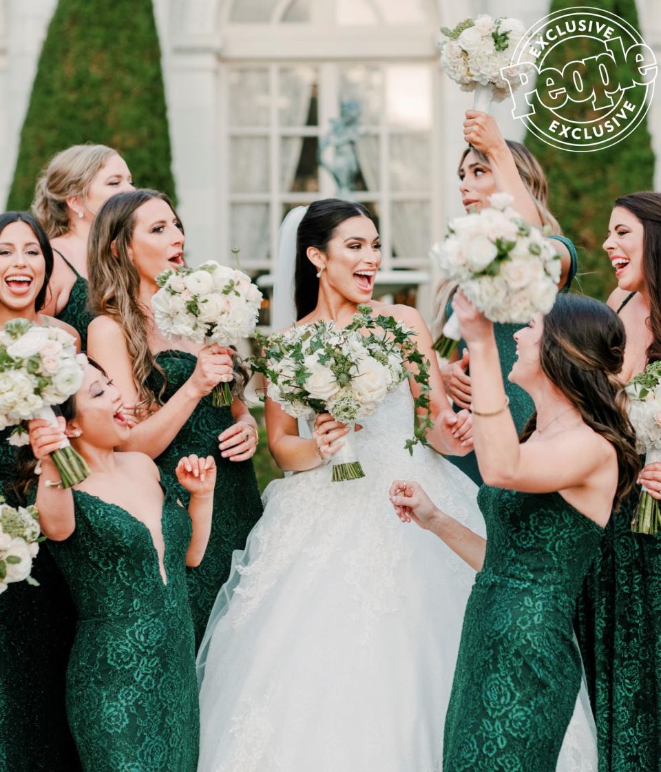 "All my best friends, I had to have in my bridal party," says Iaconetti, whose sister Lauren served as maid of honor. "I've known [almost all 11 girls] for seven, eight years plus, and they've been major parts of my life." All 11 bridesmaids wore emerald-green gowns by <a href="https://www.tarikediz.com/" rel="nofollow noopener" target="_blank" data-ylk="slk:Tarik Ediz;elm:context_link;itc:0;sec:content-canvas" class="link ">Tarik Ediz</a>. While <em>Bachelor</em> alum and bridesmaid <a href="https://people.com/parents/jade-roper-tanner-tolbert-welcome-son/" rel="nofollow noopener" target="_blank" data-ylk="slk:Jade Roper Tolbert and her husband Tanner were unable;elm:context_link;itc:0;sec:content-canvas" class="link ">Jade Roper Tolbert and her husband Tanner were unable</a> to attend, the couple surprised the newlyweds with a video that played during the reception. "They had [their newborn son] Brooks in their hands and Emmy was right next to them," says Haibon. "Tanner was talking about his own wedding that was televised. Ashley cried [back] then, saying 'When is it gonna be my turn?' And he said, 'Well, Ashley ... now it's your turn!' We feel really lucky."