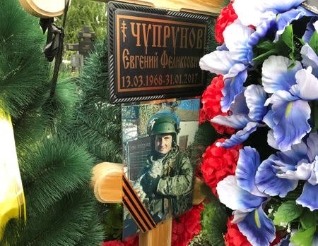 A portrait of Russian private military contractor Yevgeni Chuprunov is seen at his grave in Novomoskovsk, in Tula region, Russia June 1, 2017. REUTERS/Maria Tsvetkova