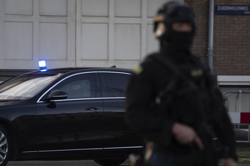 Masked and armed Dutch police guard a transport of some of the suspects who arrived at the high security court building where the trial openes in Amsterdam, Netherlands, Tuesday, Jan. 23, 2024, for suspects in the slaying of campaigning Dutch journalist Peter R. De Vries. A long-delayed trial opened Tuesday of nine men accused of involvement in the fatal shooting on a downtown Amsterdam street of Dutch investigative reporter de Vries. (AP Photo/Peter Dejong)