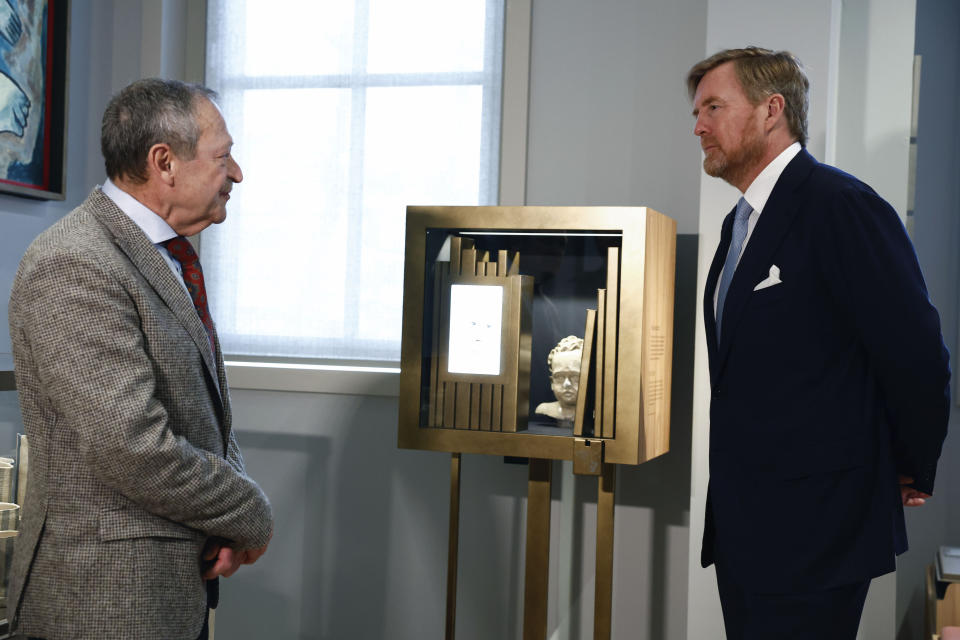 Netherlands' King Willem Alexander, right, tours the National Holocaust Museum in Amsterdam, Netherlands, Sunday, March 10, 2024. The Netherlands's National Holocaust Museum is opening on Sunday in a ceremony presided over by the Dutch king as well as Israeli President Isaac Herzog, whose presence is prompting protest because of Israel's deadly offensive against Palestinians in Gaza. (Piroschka van de Wouw/Pool Photo via AP)