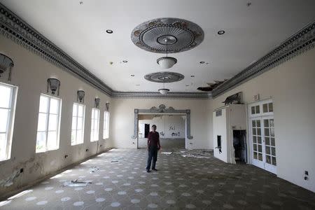 Caretaker Osvaldo "Papo" Marrero gives a tour of what was once the ballroom of the luxury Normandie Hotel, closed since 2008, in San Juan, Puerto Rico, July 18, 2015. REUTERS/Alvin Baez