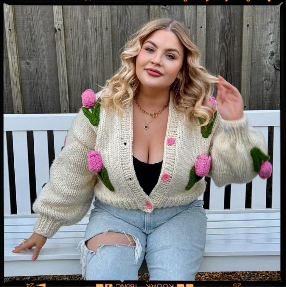 a blonde woman sitting on a bench