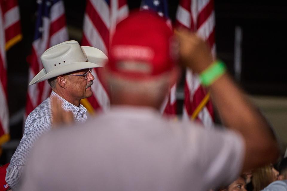 Candidate for Secretary of State Mark Finchem stands after being commended by former President Donald Trump during his rally at Legacy Sports Park in Mesa on Sunday, Oct. 9, 2022.