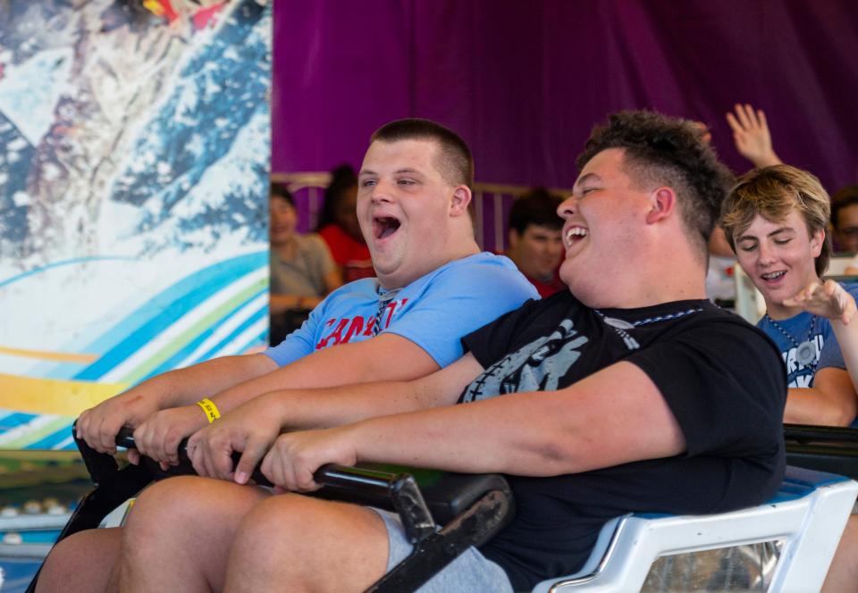 Drew Carter, left, enjoys the rides with Dylan Baker during Special Kids Day at the 2023 West Side Nut Club Fall Festival in Evansville, Ind., Tuesday, Oct. 3, 2023.