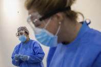 Madrid Emergency Service (SUMMA) health workers conduct rapid antigen tests for COVID-19 in the southern neighbourhood of Vallecas in Madrid, Spain, Tuesday, Sept. 29, 2020. Madrid has a rate of infection 2.5 times higher than the national average, which is already three times the European average, including the UK. (AP Photo/Bernat Armangue)