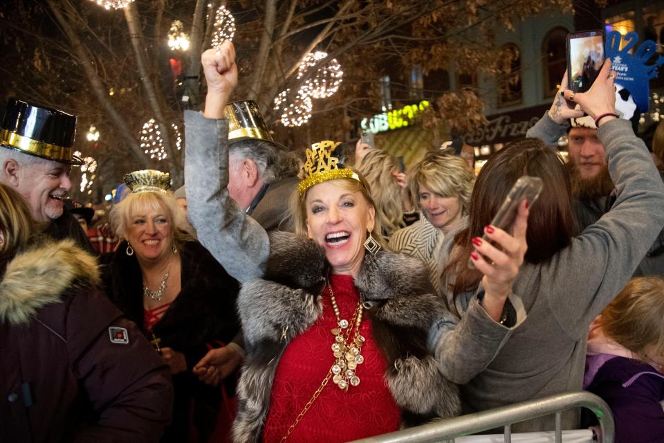 A woman cheers with the other thousands  of people packed into Market Square to celebrate the new year during New Year's Eve on the Square on Wednesday, January 1, 2020.