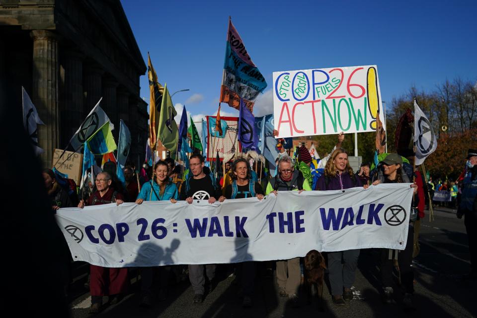 Pilgrimage groups who have walked to Glasgow are joined by members of the group, Extinction Rebellion as they walk to raise awareness of the climate crisis on October 30, 2021 in Glasgow, Scotland. The protest forms part of a series of events to be held throughout the COP 26 climate summit to raise awareness of the climate crisis.