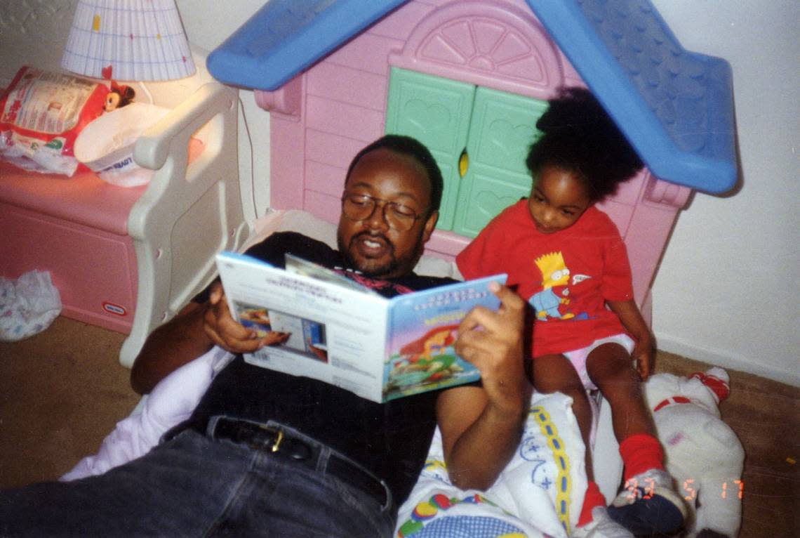In this family file photo from the early-1990’s Leonard Pitts Jr. reads to his daughter, Onjel.