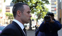 Oscar Pistorius leaves the high court in Pretoria, South Africa, Wednesday, May 14, 2014. Pistorius is charged with murder for the shooting death of his girlfriend, Reeva Steenkamp, on Valentines Day in 2013. A judge ruled on Wednesday, that Pistorius be sent for psychiatric observation. (AP Photo/Themba Hadebe)
