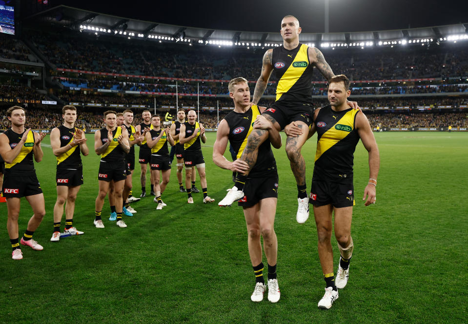 MELBOURNE, AUSTRALIA - JUNE 15: Dustin Martin of the Tigers is chaired from the field after his 300th match by teammates Tom Lynch (left) and Toby Nankervis (right0 during the 2024 AFL Round 14 match between the Richmond Tigers and the Hawthorn Hawks at The Melbourne Cricket Ground on June 15, 2024 in Melbourne, Australia. (Photo by Michael Willson/AFL Photos via Getty Images)