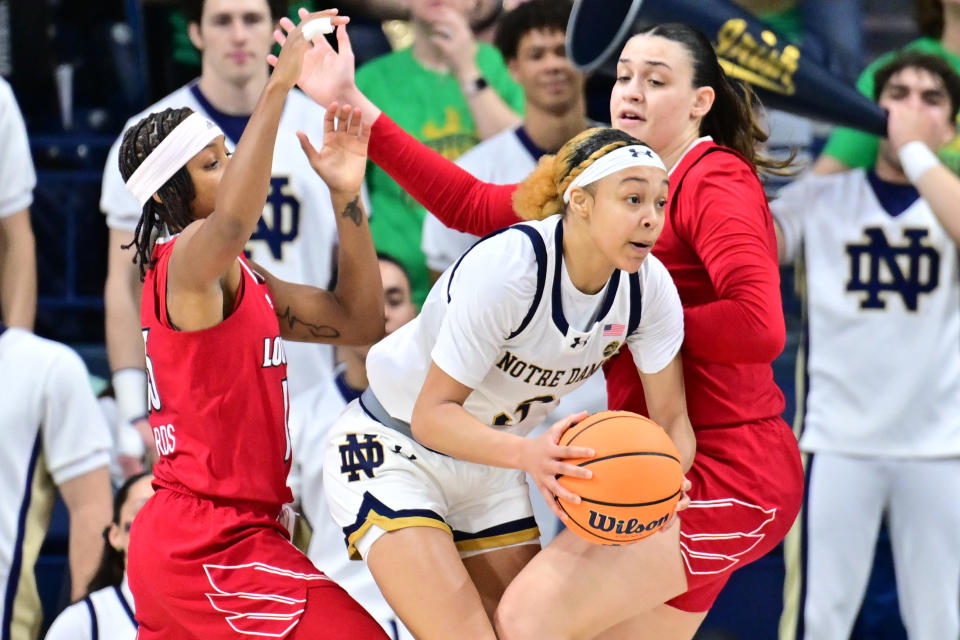 Mar 3, 2024; South Bend, Indiana, USA; Notre Dame Fighting Irish guard Hannah Hidalgo (3) passes the ball as Louisville Cardinals guard Nina Rickards (15) and forward Elif Istanbulluoglu (11) defend in the first half at the Purcell Pavilion. Matt Cashore-USA TODAY Sports