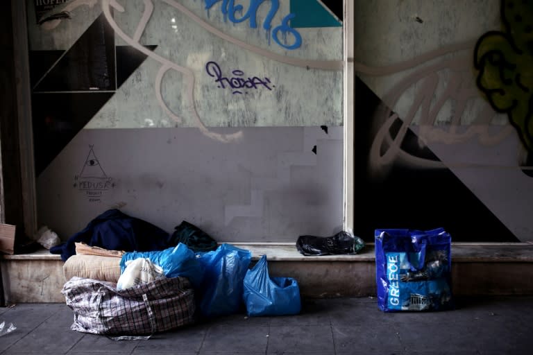 The belongings of a homeless person outside a closed shop in the centre of Athens