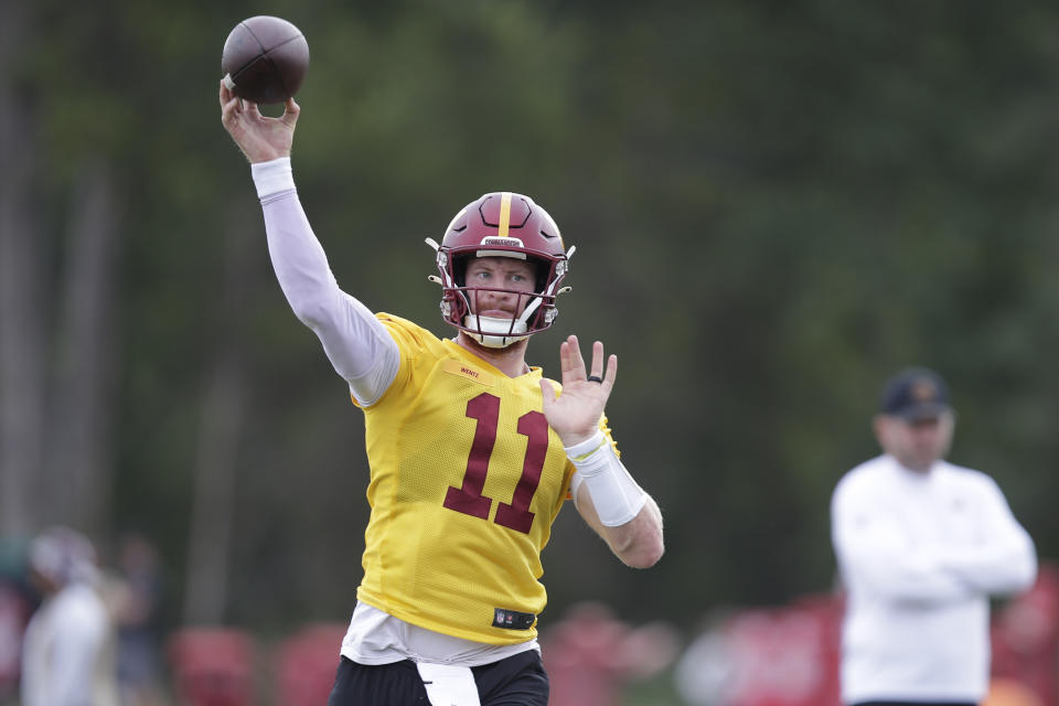 Washington Commanders quarterback Carson Wentz throws a pass during an NFL football practice at Inova Sports Performance Center in Ashburn, Va., Wednesday, Aug. 17, 2022. (AP Photo/Luis M. Alvarez)