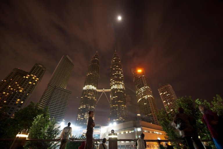 People gather in front of Malaysia's iconic Patronas Twin Towers in Kuala Lumpur on March 31, 2012. Malaysia has been rated the world's top Muslim-friendly holiday destination in a survey that listed Egypt, Turkey, United Arab Emirates, Saudi Arabia and Singapore as runners-up