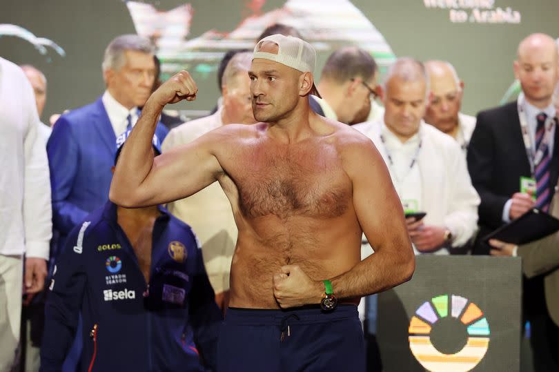 Tyson Fury poses after weighing in