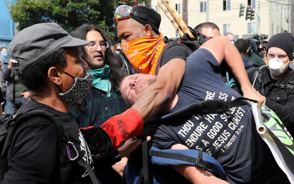 Protesters remove a man from the protest because he was bothering other protesters at the self-proclaimed Capitol Hill Autonomous Zone - REUTERS/Goran Tomasevic