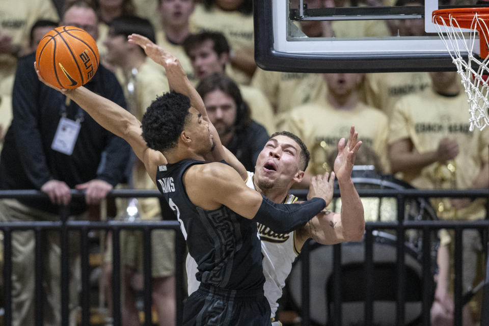 FILE - Michigan State guard Jaden Akins (3) shoots while being defended by Purdue forward Mason Gillis (0) during an NCAA college basketball game, Saturday, March 2, 2024, in West Lafayette, Ind. Purdue is back in the NCAA Tournament with a No. 1 seed with the goal of regrouping from last year's shocking upset loss to Fairleigh Dickinson. Gillis said the Boilermakers can’t change the FDU loss so they can only focus on playing well in this year’s NCAA Tournament.(AP Photo/Doug McSchooler)