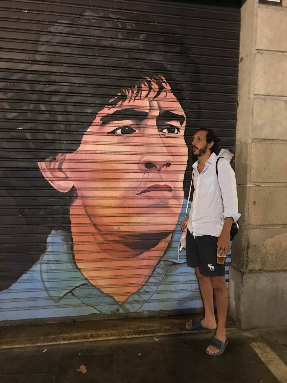 jordan partner standing infront of mural of Diego Maradona