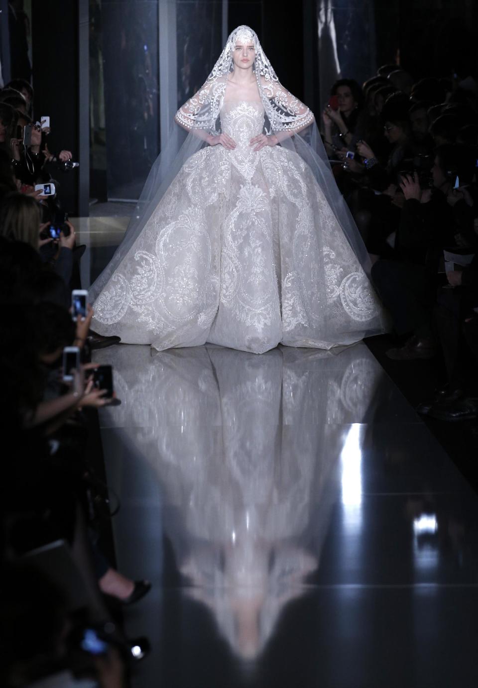 A model wears the wedding gown by Lebanese fashion designer Elie Saab for his Spring Summer 2013 Haute Couture fashion collection, presented in Paris, Wednesday, Jan.23, 2013. (AP Photo/Christophe Ena)