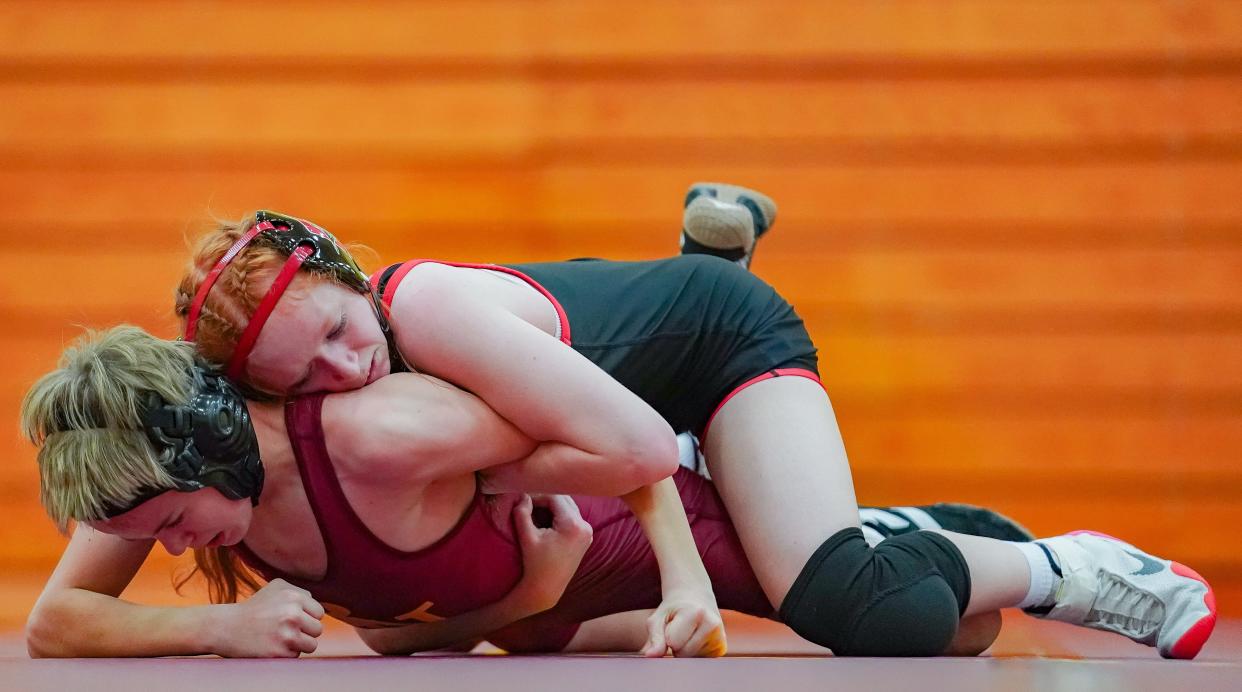 Bloomington North's Kyle Burton (bottom) wrestles against Edgewood’s Katelyn Holmes in the 106-pound match during their dual meet at North on Tuesday, Jan. 9, 2024.