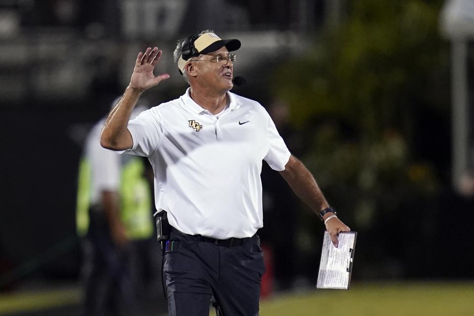 Central Florida head coach Gus Malzahn has words with an official over a penalty during the first half of an NCAA college football game against Louisville, Friday, Sept. 9, 2022, in Orlando, Fla. (AP Photo/John Raoux)