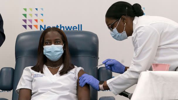 PHOTO: Caption *Sandra Lindsay, left, a nurse at Long Island Jewish Medical Center, is inoculated with the COVID-19 vaccine by Dr. Michelle Chester, Dec. 14, 2020, in Queens, New York. (Pool via Getty Images)