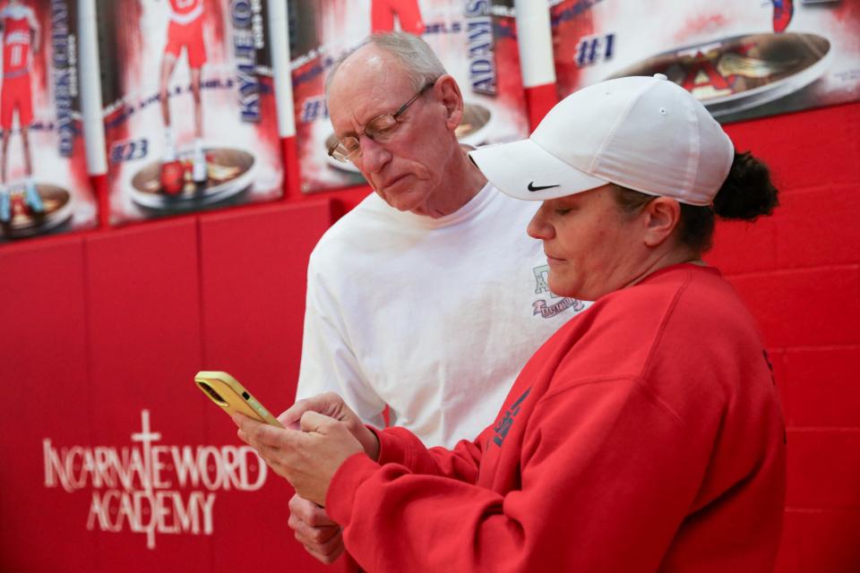 Girls basketball coaches Malcolm Smith and Jessica Sachanowicz look at opponent stats before practice at Incarnate Word Academy on Monday, Feb. 12, 2024, in Corpus Christi, Texas.