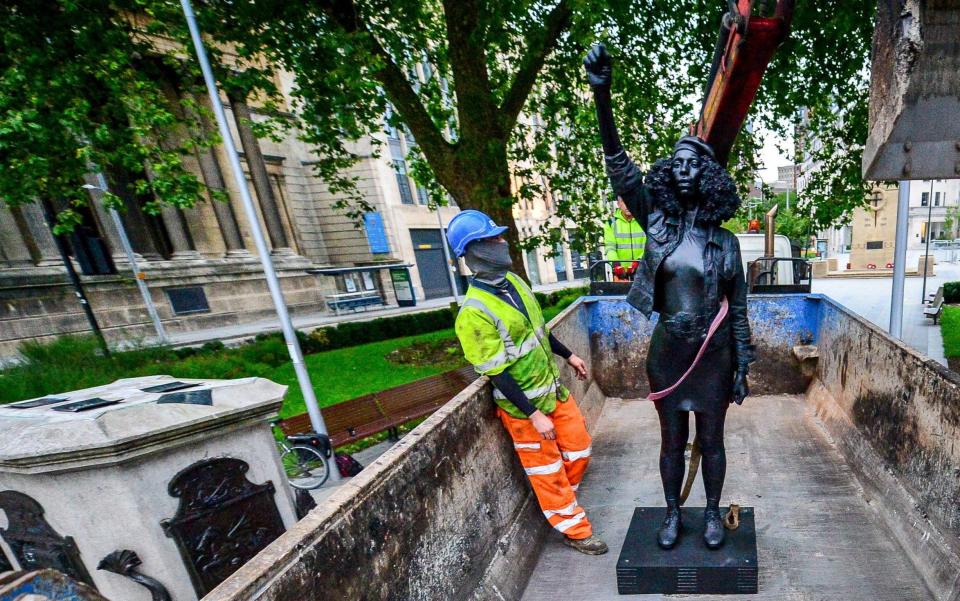 The statue, entitled A Surge of Power (Jen Reid) 2020, is removed from the plinth and loaded into a recycling and skip hire lorry by contractors - PA