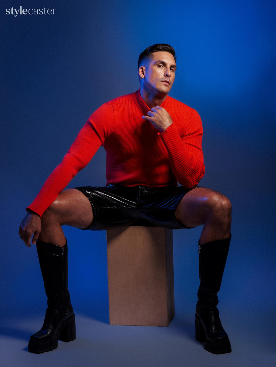 PHOTO: GEORGE CHINSEE. KNIT SWEATER AND VINYL SHORTS: Courrèges. LEATHER BOOTS. SYRO. Earring: Bond Hardware.