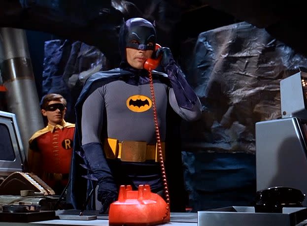 Batman answers the Batphone in the 1966 series. (Photo: Warner Bros.)