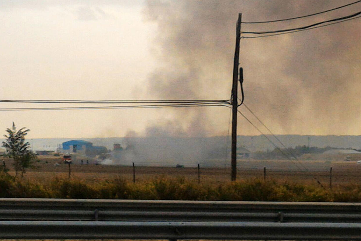 Accident: Smoke rises from the scene of the crash about 15 miles out of Madrid: EPA