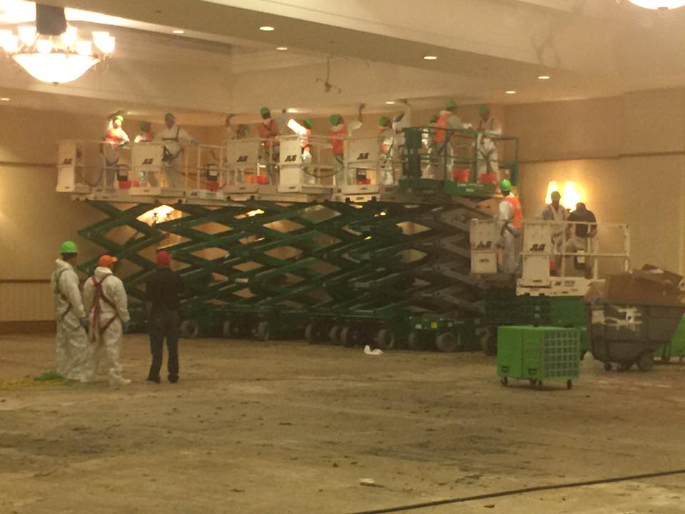 Servpro technicians clean soot off of the ceiling in a ballroom in St. Johns County following a fire. Employees use a hydraulic lift to deal with the damage.