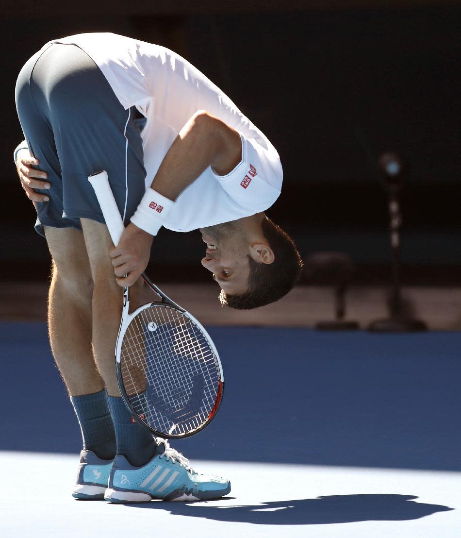 Serbia's Novak Djokovic bends over while playing Uzbekistan's Denis Istomin during their second round match at the Australian Open tennis championships in Melbourne, Australia, Thursday, Jan. 19, 2017. (AP Photo/Kin Cheung)