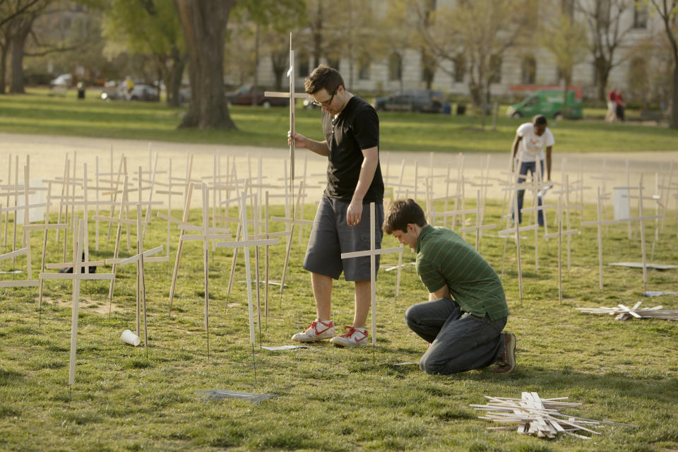 Volunteers set up 3,300 grave markers representing gun violence deaths since Newtown 