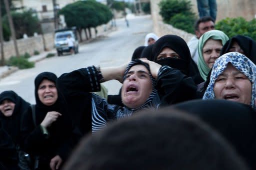 Syrian relatives mourn during funeral of Syria's violence victim, Mohammed Ahmed Rahim, in Qorqania village, north of Idlib province