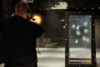 Armoured One Tactical Consultant Michael Poland shoots one of the company's security glass for an active shooter preparedness drill demonstration at Rockland Indoor Shooting, in Pearl River, New York, U.S., December 12, 2017. REUTERS/Eduardo Munoz