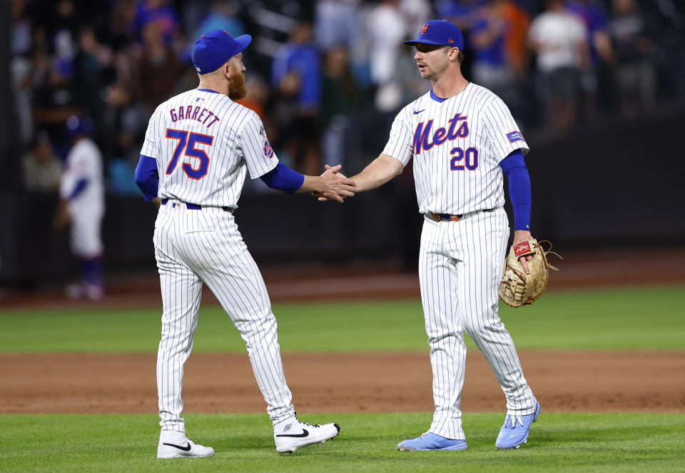 New York Mets pitcher Reed Garrett shakes hands with first baseman Pete Alonso (20) after the Mets defeated the Arizona Diamondbacks 3-2 in a baseball game Thursday, May 30, 2024, in New York. (AP Photo/Noah K. Murray)