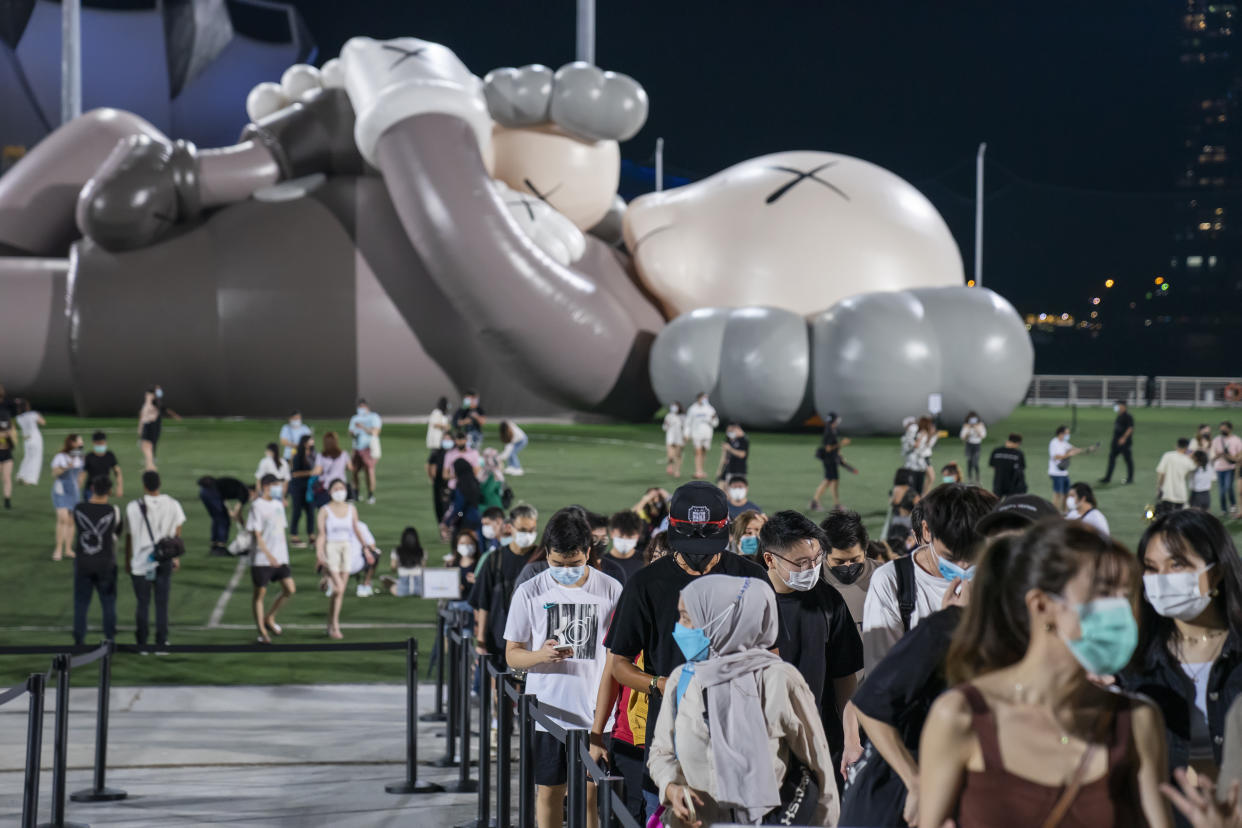 Visitors wearing face masks at the Kaws: Holiday Singapore exhibition in Singapore in 2021. (Getty Images file photo)