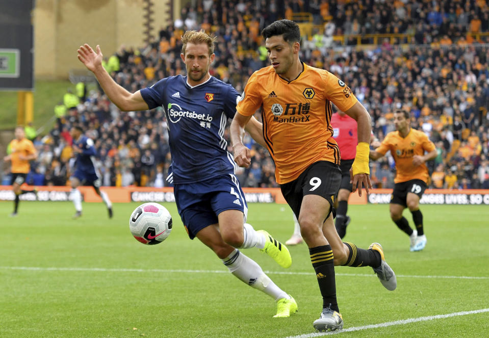 Watford's Craig Dawson, left, and Wolverhampton Wanderers' Raul Jimenez in action during their English Premier League soccer match at Molineux Stadium in Wolverhampton, England, Saturday Sept. 28, 2019. (Dave Howarth/PA via AP)