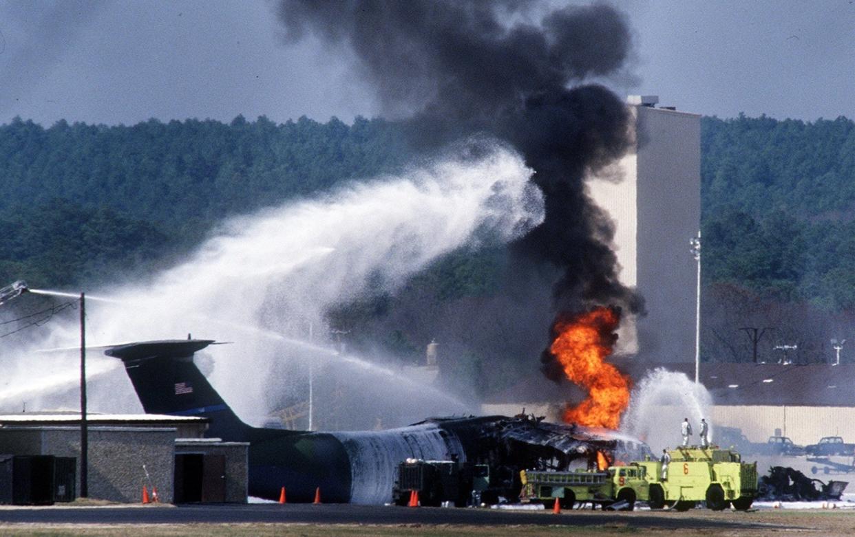 A C-141 transport plane is shown on March 23, 1994, after an F-16 fighter jet crashed into the plane as it was parked on the Pope Air Force Base flight line.