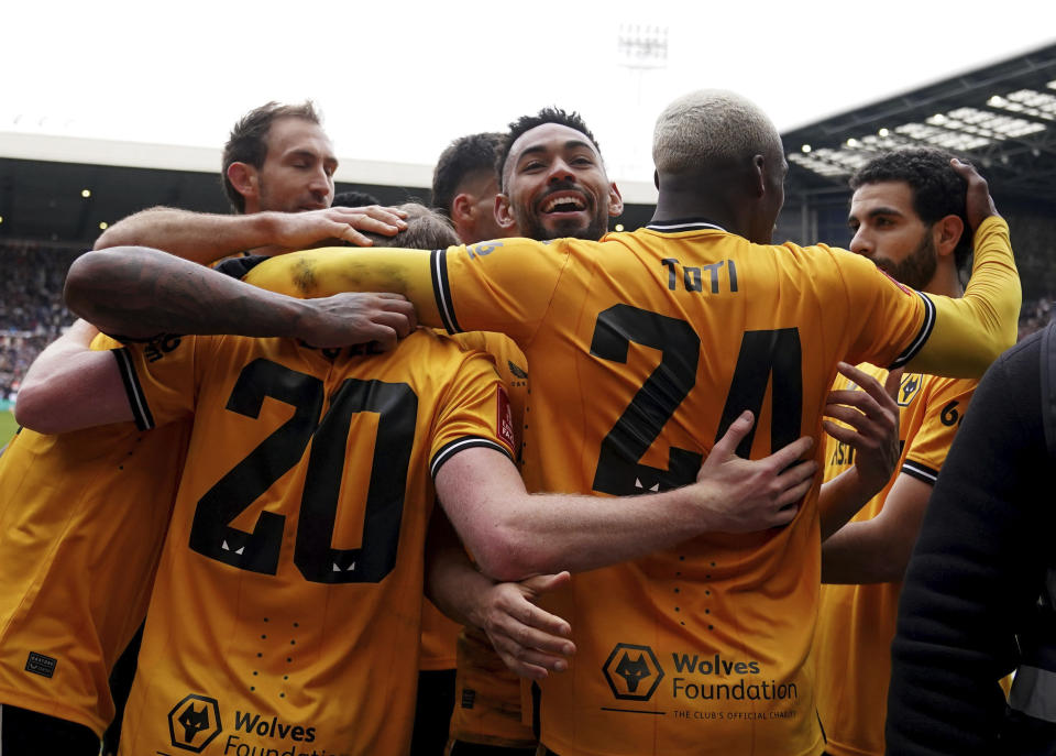 Wolverhampton Wanderers' Matheus Cunha celebrates scoring his sides second goal of the game with teammates, during the English FA Cup fourth round soccer match between West Bromwich Albion and Wolverhampton Wanderers, at The Hawthorns, in West Bromwich, England, Sunday, Jan. 28, 2024. (Bradley Collyer/PA via AP)