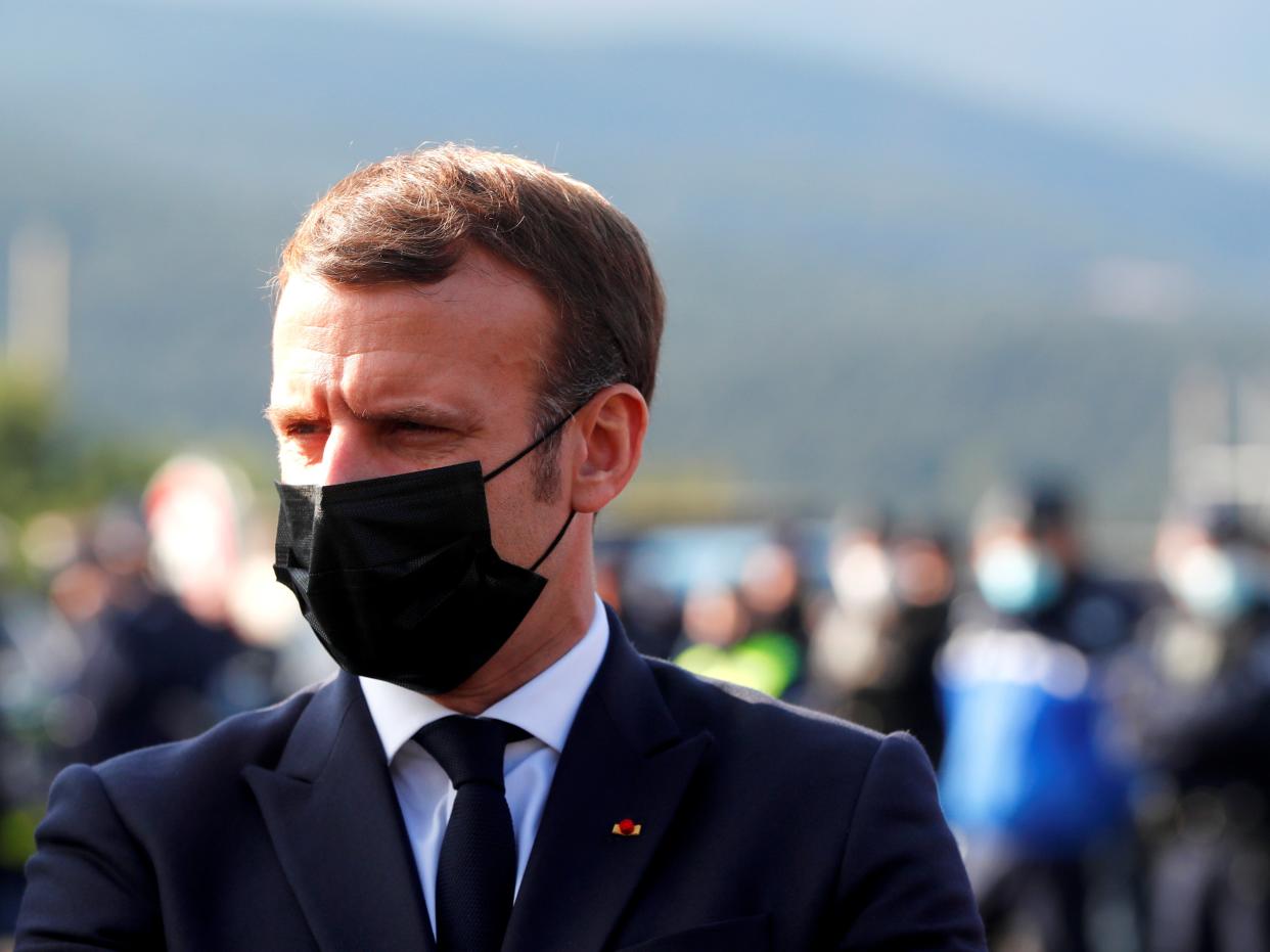 The French president speaks to police officers during a visit to the Le Perthus border crossing (Guillaume Horcajuelo/Pool via REUTERS)