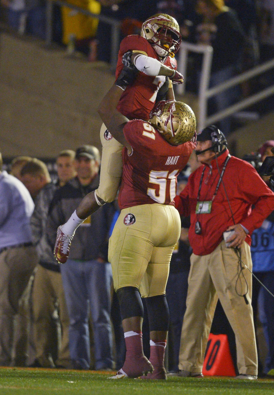 Florida State's Bobby Hart holds up Levonte Whitfield after Whitfield's 100-yard run back of a kickoff during the second half of the NCAA BCS National Championship college football game against Auburn Monday, Jan. 6, 2014, in Pasadena, Calif. (AP Photo/Mark J. Terrill)