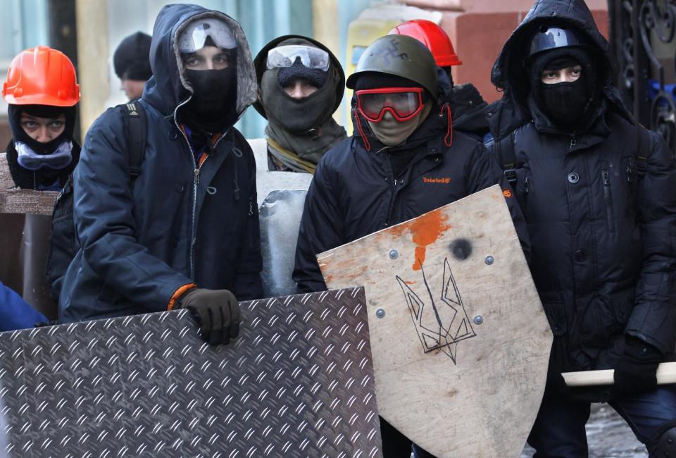 Protesters attend a march in central Kiev, Ukraine, Monday, Jan. 27, 2014. Ukraine's justice minister is threatening to call for a state of emergency unless protesters leave her ministry building, which they occupied during the night. The seizure of the building early Monday underlined how anti-government demonstrators are increasingly willing to take dramatic action as they push for the president's resignation and other concessions. (AP Photo/Sergei Grits)