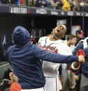 Braves pinch hitter Jorge Soler celebrates his game winning solo homer with Orlando Arcia in the dugout against the Astros in game 4 of the World Series in Atlanta on Saturday, Oct. 30, 2021. (Curtis Compton/Atlanta Journal-Constitution via AP)