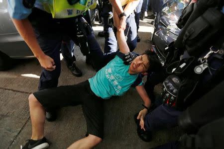 Pro-democracy activist Joshua Wong is detained by police as he takes part in a protest demanding the release of Chinese Nobel rights activist Liu Xiaobo, during Chinese President Xi Jinping's visit in Hong Kong, China July 1, 2017. REUTERS/Tyrone Siu