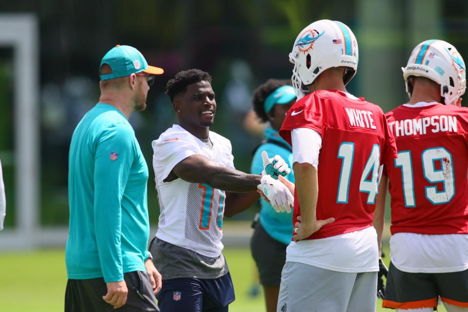 Jun 4, 2024; Miami Gardens, FL, USA; Miami Dolphins wide receiver Tyreek Hill (10) shakes hands with quarterback Mike White (14) during mandatory minicamp at Baptist Health Training Complex. Mandatory Credit: Sam Navarro-USA TODAY Sports