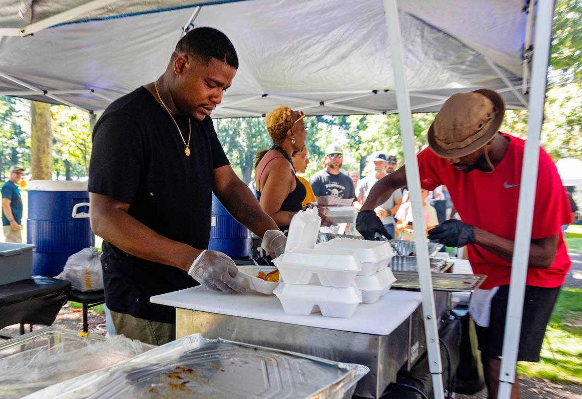 Jody Charles, left, owner of Louisiana Soul Bayou, prepares food orders at the Boise Soul Food Festival in 2022.